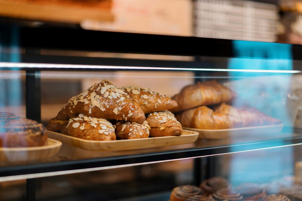 Croissant with almonds on the counter of bakery shop
